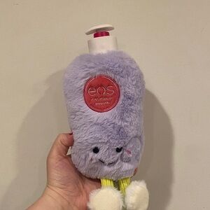 eos Lavender Plush Hand Lotion Cover with Red Logo and White Pom slippers